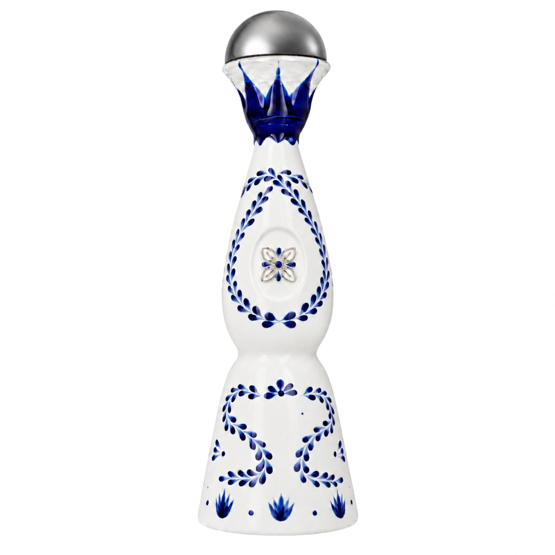 A Clase Azul bottle containing blue hand-painted floral patterns and a silver faceted glass top, shown on a solid white background.