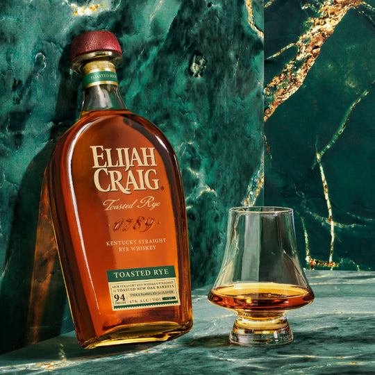 Bottle of Elijah Craig Toasted Rye Whiskey with a glass of whiskey