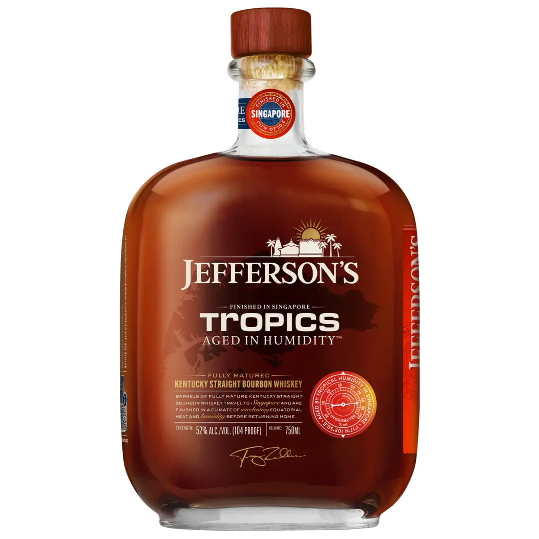 A bottle of Jefferson's Tropics bourbon whiskey with a label indicating it is aged in humidity and finished in Singapore. The bottle is clear, showcasing the amber-colored whiskey inside.